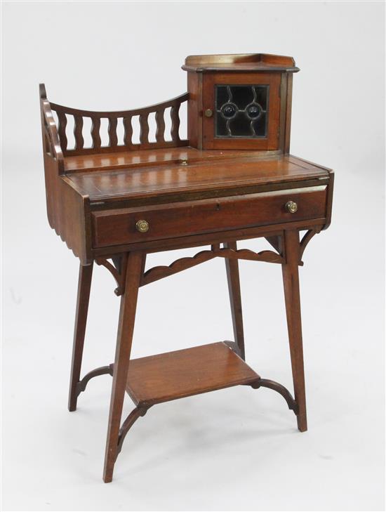 An Arts & Crafts walnut writing table, in the manner of Liberty, W.2ft 2in.